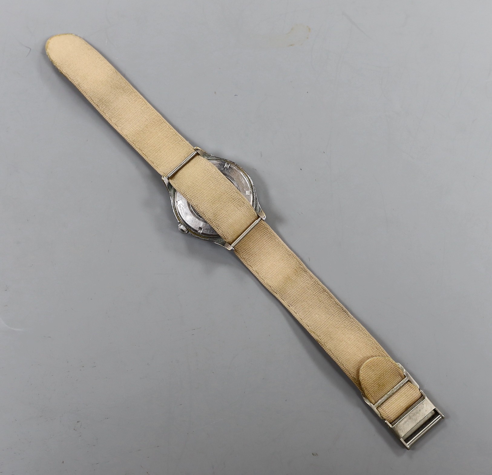 A gentleman's early 1940's stainless steel Omega manual wind wrist watch, on associated fabric strap.